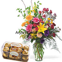 Pink Roses, Orange Gerberas And Yellow Lilies with Some Ferns In Glass Vase Along with A Box of 16 Pcs Ferrero Rocher